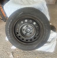 Full view of tire with steel rim showing brand Certified Alltrek