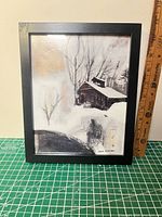 Framed winter landscape print with ruler for scale