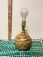 Front view showing entire lamp with bulb and ruler for scale