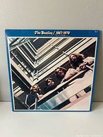 Front cover showing title and band members looking down stairwell