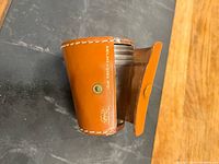 Leather carrying case closed, cups partially visible