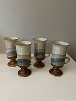 Four pedestal mugs front view