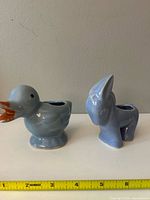 Duck and donkey ceramic planters side by side with ruler showing size