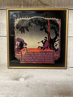 Front view of framed reverse-painted glass art showing poem and silhouette scene