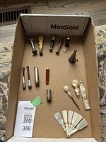 Overhead view of all items including wax stampers, cigar holders, pewter taper stick holder, fan blades, and accessory cases