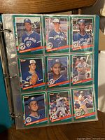 Binder page with 9 Toronto Blue Jays baseball cards displayed in plastic sleeves. Cards mainly feature players posing in Blue Jays uniforms with a vintage style design.