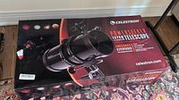 Sealed retail box front showing Celestron PowerSeeker 127EQ branding and included eyepieces.