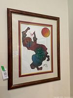 Framed original abstract painting by Billy Molokeng hanging on wall.