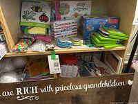 Craft kits on shelf including sticker craft, beads, origami kit, friendship bracelet kit, and fuse beads