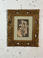 Full view of the rustic framed art print showing traditional Balinese dancers and the carved wood frame with floral motifs.