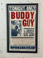 Front view of framed Buddy Guy 2001 North American Tour poster showing title text, black and white photo of Buddy Guy, and list of tour cities across North America.