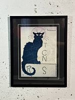 Front view of framed artwork showing the 'Tournee du Chat Noir' black cat poster in a black wooden frame.