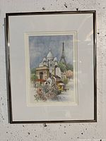 Full view of the framed print depicting iconic Paris landmarks with floral and market scene.