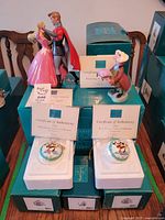 Group shot of four ceramic pieces with certificates and original boxes