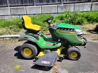 Right side profile showing deck, seat, rear and front wheels, and John Deere decal