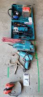 Open teal Makita carrying case showing power tools and accessories