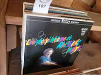 Photo showing vinyl record albums including 'Everybody's Welcome at McNeill's Party'.