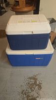 Two stacked Coleman coolers, medium and large sizes shown from the outside.