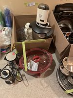 View of entire lot showing Hamilton Beach coffee maker, Rival crockpot with glass lid, coffee carafes, grinder and accessories inside a box