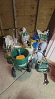 Photo overview of lawn spreader, fertilizer bags, pressure sprayers, and weed/moss control items