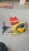View of the primary pneumatic tools, air ratchet, air hoses, and socket set