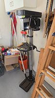 Full view of floor drill press showing head, column, tilt table, base