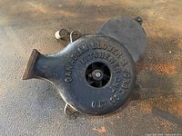 Top view showing embossed front with brand and model text and internal fan blades visible.