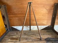 Full view of the 54-inch wooden tripod standing fully extended showing its three legs with metal clamps and wooden construction with patina.