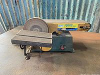 Front view of the Craftex benchtop sander showing the 6-inch disc, 4-inch belt, adjustable work table, and housing.