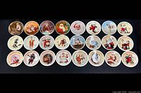 Top-down photo showing all 24 Norman Rockwell Christmas collector plates arranged in 3 rows on black background, highlighting varied seasonal artwork.