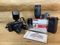 Complete Nikon F-401s 35mm film camera kit with lenses, original boxes, manuals, and Nikon SB-22 flash.