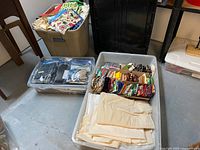 Overview photo of three storage containers filled with assorted quilting and crafting fabrics including fat quarters, muslin yardage, and various fabric pieces.