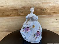 Front view of Royal Doulton figurine Marilyn HN3002 showing the woman in white floral gown holding a fan