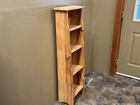 Left side profile view showing natural wood finish and curved side edges of the cabinet.