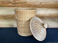 Tall wicker hamper basket without the lid, showing the open interior and round braided rim detail.