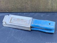 Top view of the vintage Round Head Jig model 2RHB-1060 showing the embossed identification and blue handle.