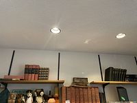 Shelf displaying multiple vintage books including 9 volumes of The Makers of Canada and assorted hardcovers