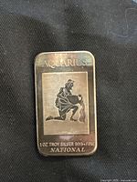 Front view of the 1 oz Troy silver bar showing Aquarius zodiac symbol and inscriptions.