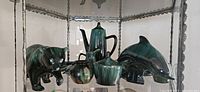 Blue Mountain Pottery and style ceramic sculptures including bear, dolphin, coffee pot, and other pottery items.