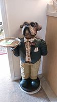 Full front view of the bulldog butler statue showing attire and tray