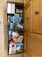 Box with various packs of light bulbs and some small light fixtures or accessories in packaging