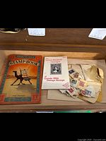 Overview of vintage stamp book, Lyman catalogue and assorted stamps in envelopes
