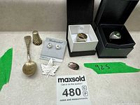 Photo showing all sterling silver items including rings, earrings, thimble, spoon, pins labeled 925