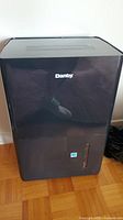Front view of the black Danby dehumidifier showing the brand logo and water level indicator slot.