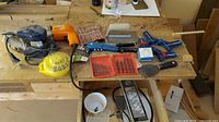Overview of entire lot on wooden workbench, various power and hand tools visible
