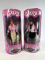 Front view of both boxed dolls