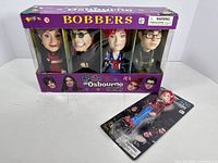 Front view of boxed set with four bobbleheads and single blister-card bobblehead