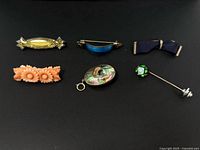 Group shot of all six pins on black background