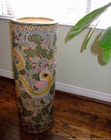 Full view of cylindrical umbrella stand showing overall pattern and shape