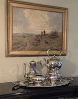 Full group on decorative tray under landscape painting